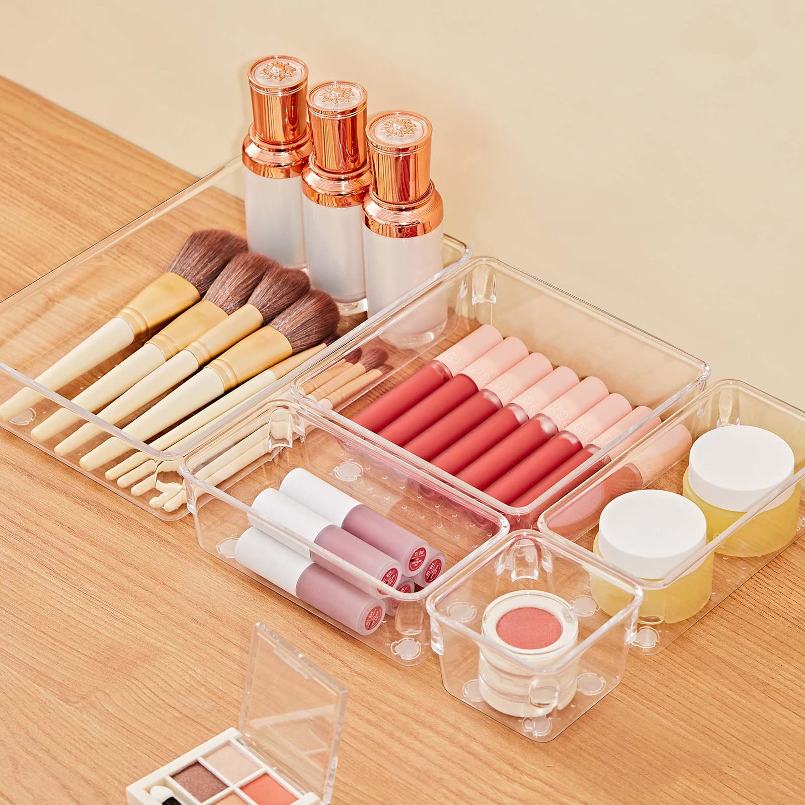 Clear 13-piece modular vanity drawer-tray organizer set, layout view — clear organizer trays holding cosmetics
