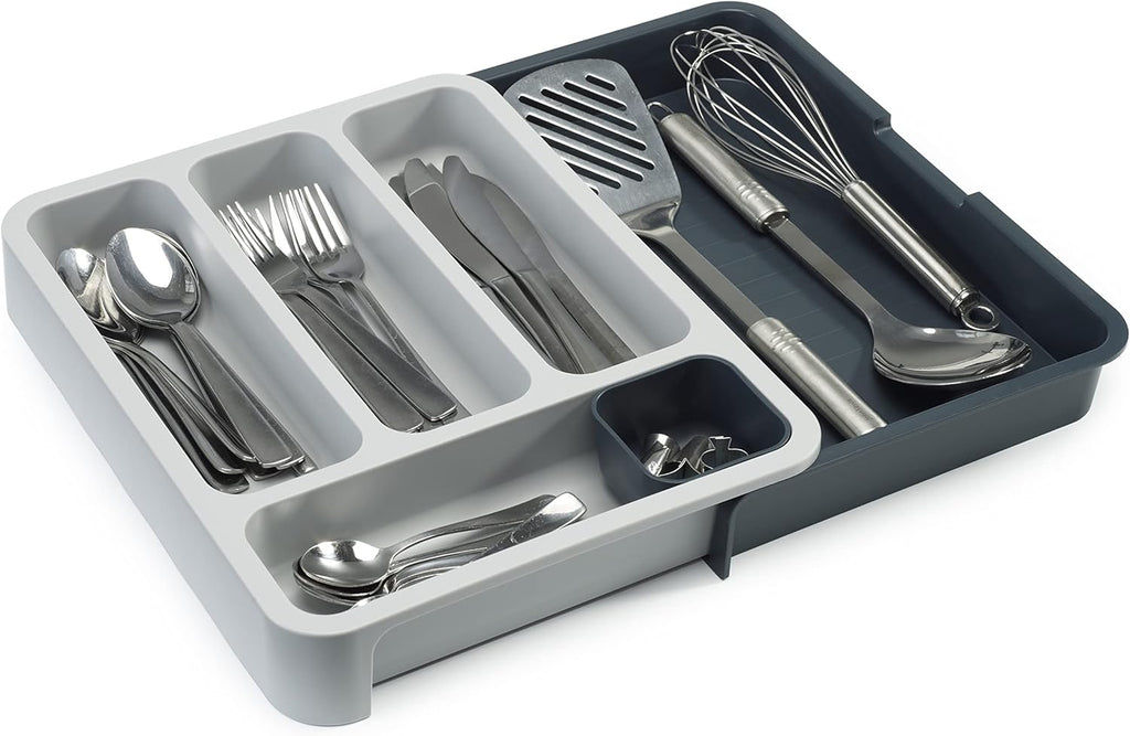 Expandable dark-gray six-compartment plastic cutlery drawer tray — expanded tray with cutlery