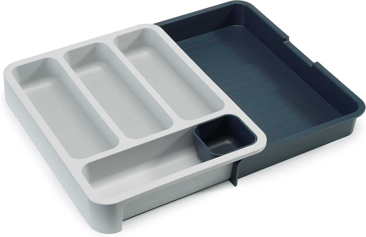 Expandable dark-gray six-compartment plastic cutlery drawer tray — expanded empty tray