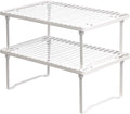 Set of two white stackable metal cabinet shelf risers — white two-tier set on a clean background