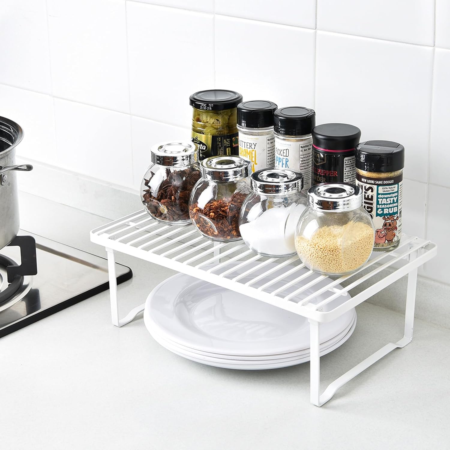 Set of two white stackable metal cabinet shelf risers — shelf riser used with dishes and pantry jars