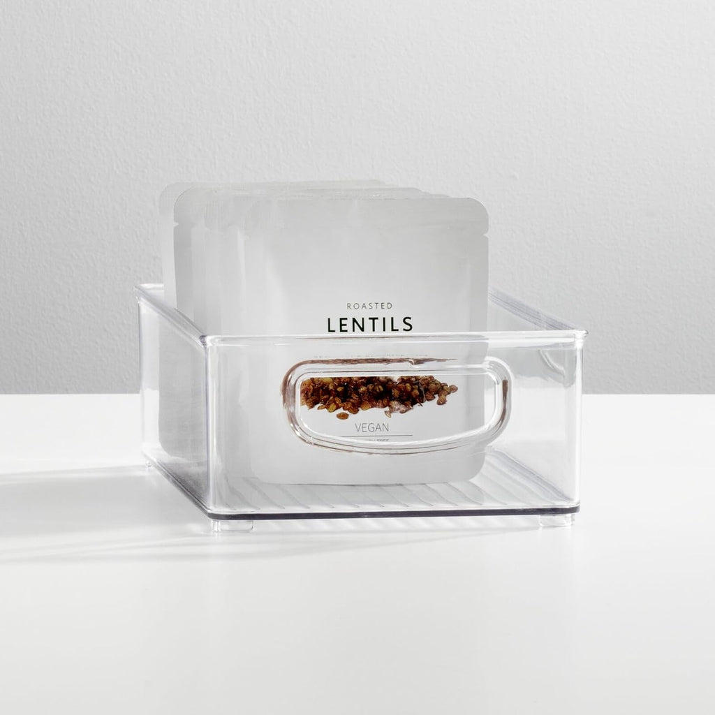 Two clear plastic handled storage bins for pantry or refrigerator organization — clear bin used for pantry storage